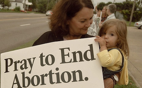 Kathy with her granddaughter, praying at her local Planned Parenthood facility.